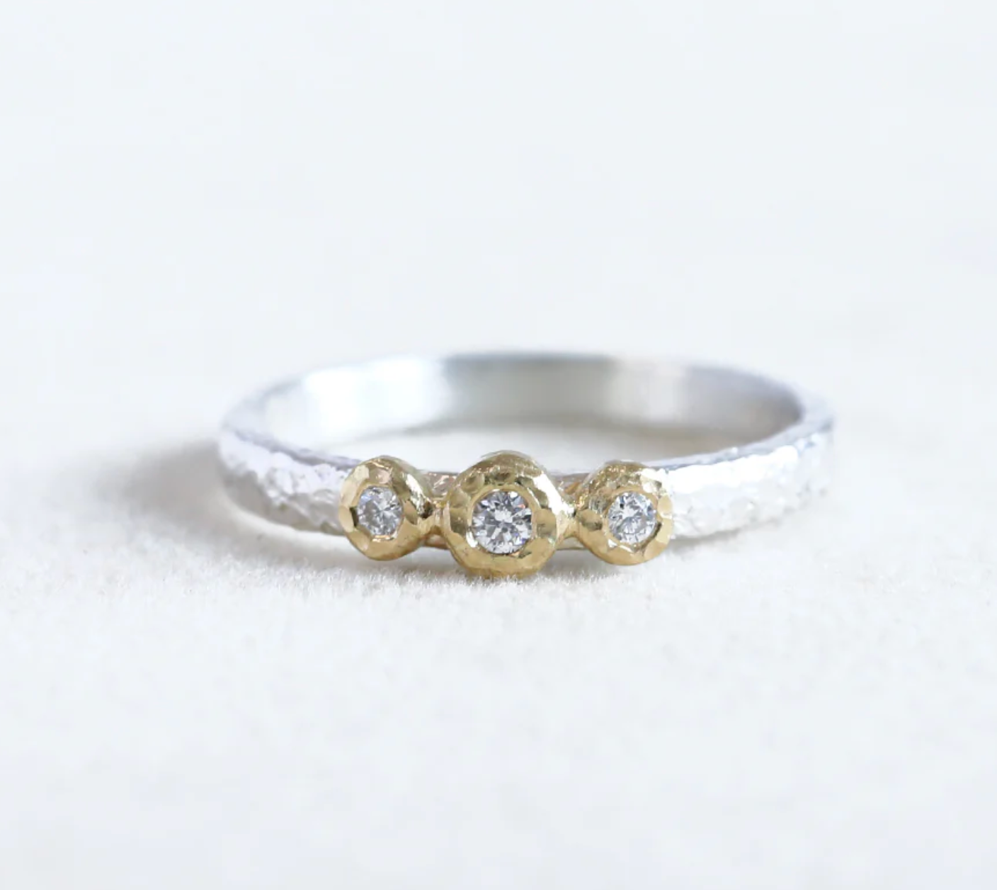 18ky 3-bezel Ring 0.07ct diamond with sterling silver band - size 5.5